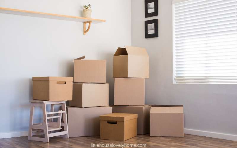 Picture of moving boxes in the corner of a white room