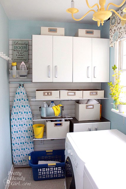 A small laundry room with a slat wall