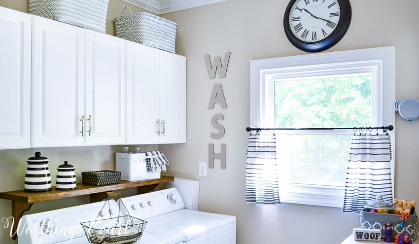 A laundry room with the word WASH on the wall