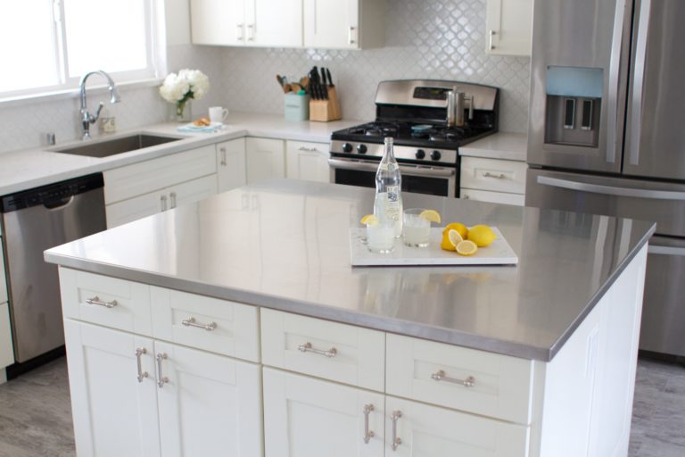 A kitchen island with stainless steel countertops 