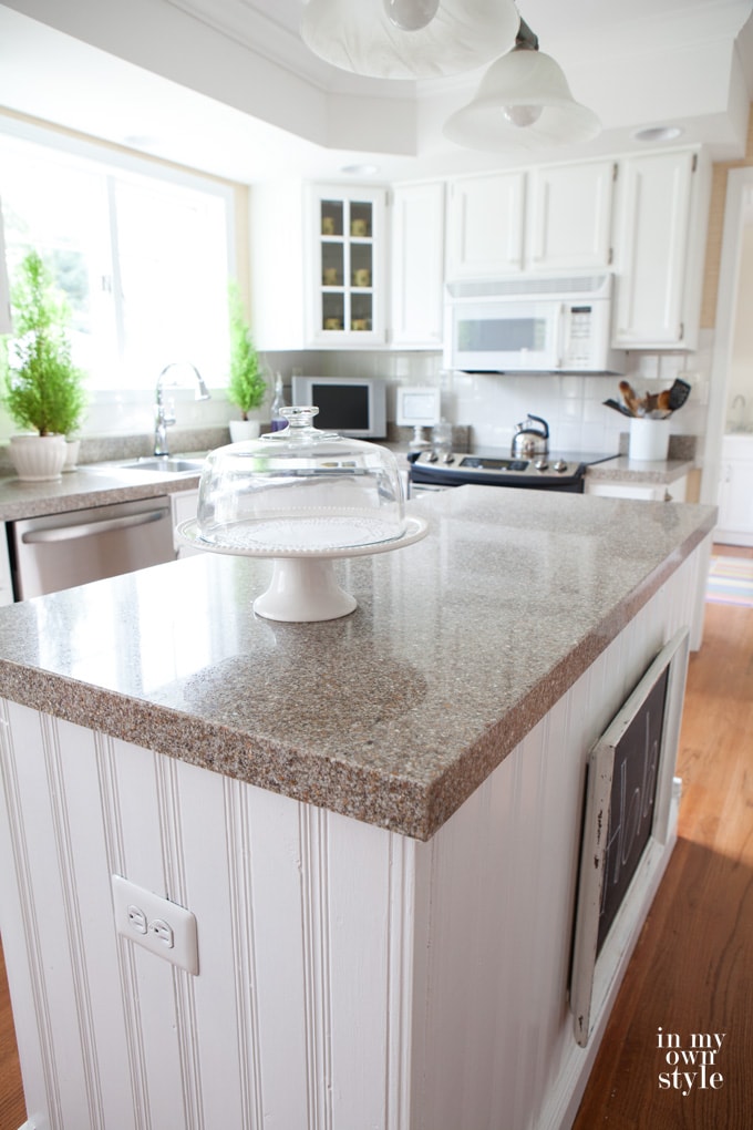 a white kitchen island with granite countertops 