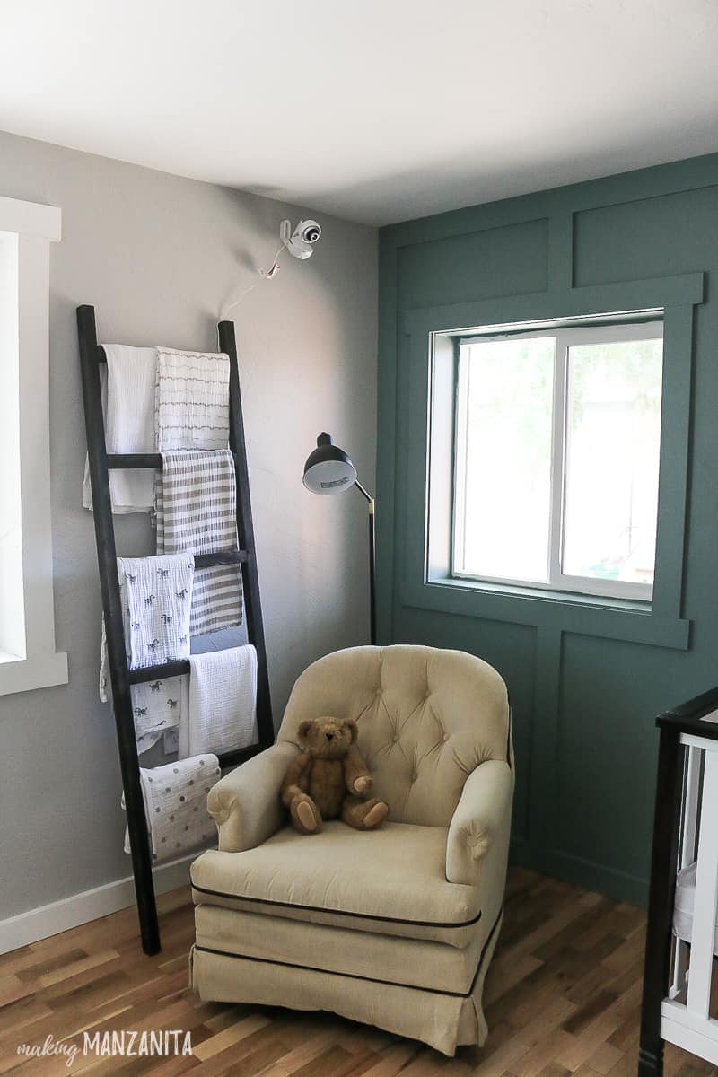 A nursery with a ladder holding blankets