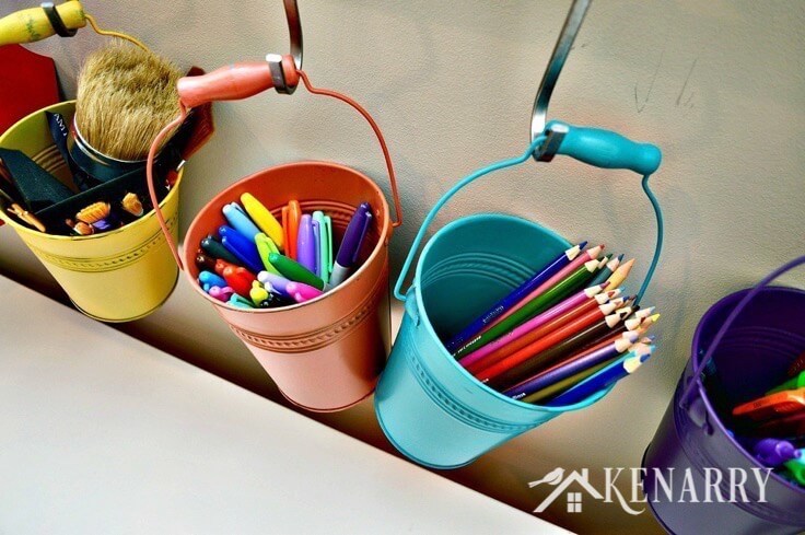 Art supplies hanging in buckets