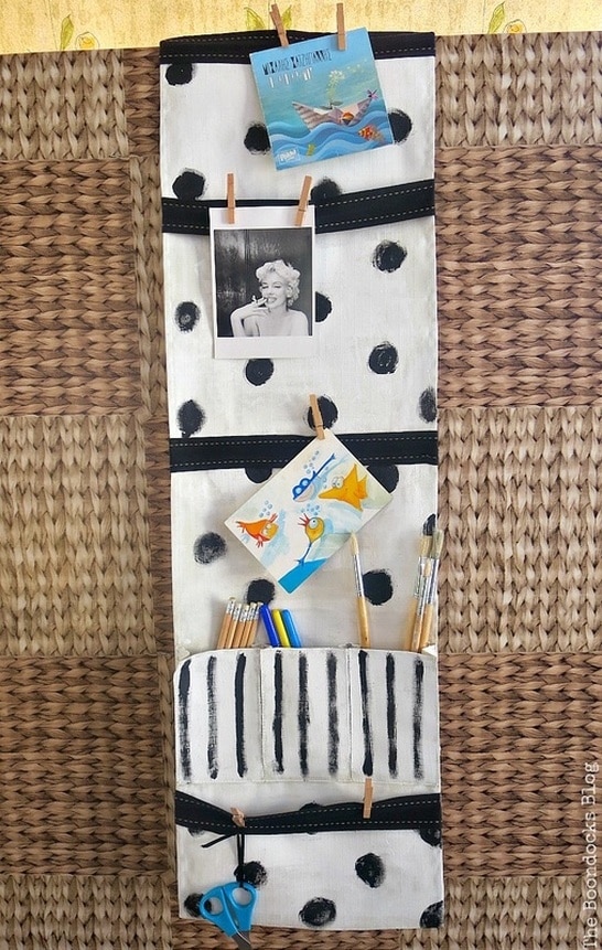 a white hanging organizer with black polka dots