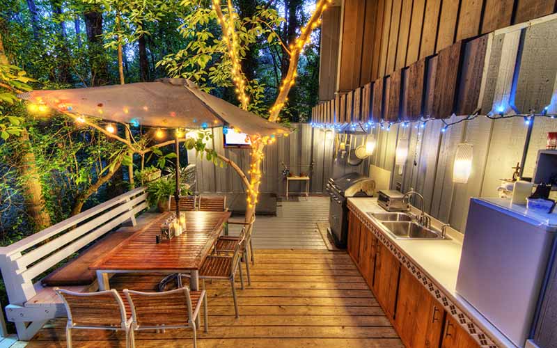 Image of barbeque area with patio lights hanging