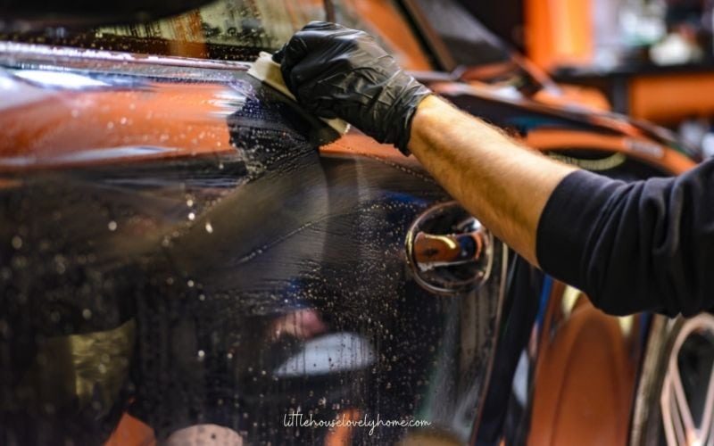 hands cleaning a car