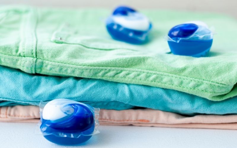 image of 3 pieces dishwasher pods beside the clothes