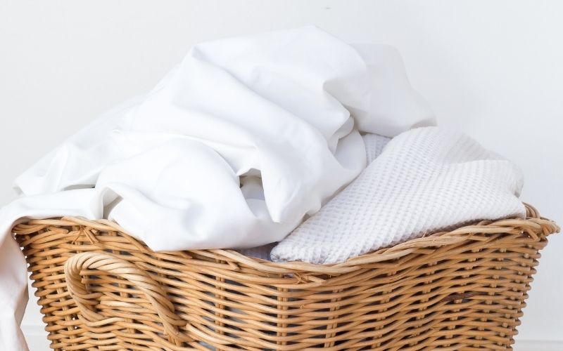 Image of a laundry basket full of white clothes