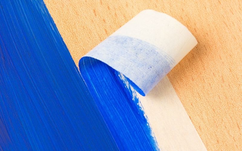 Image of a flat wood with mask tape and blue paint