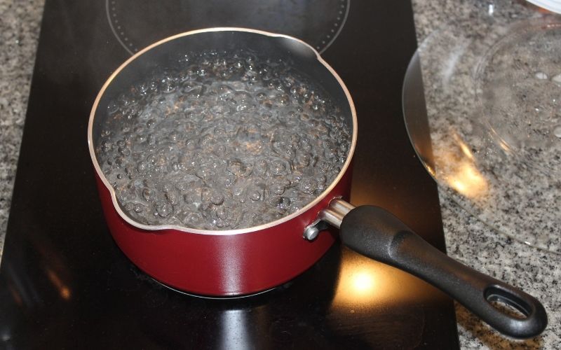Picture of a boiling water in a red pot