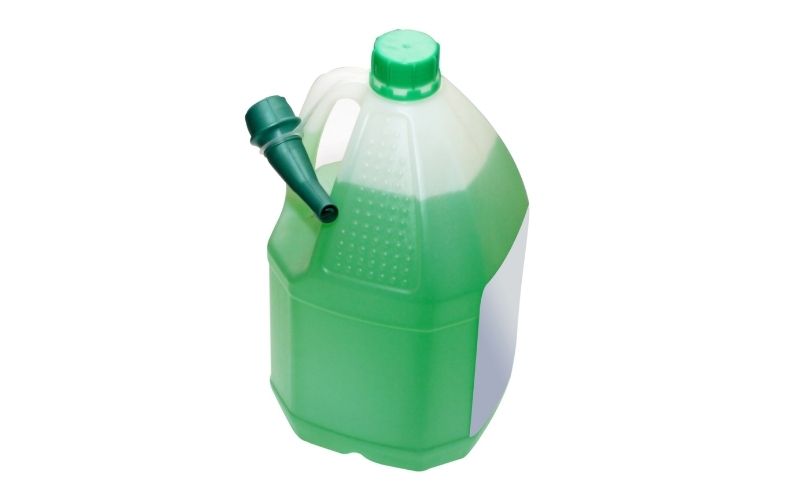 Image of a closed plastic container with green liquid 