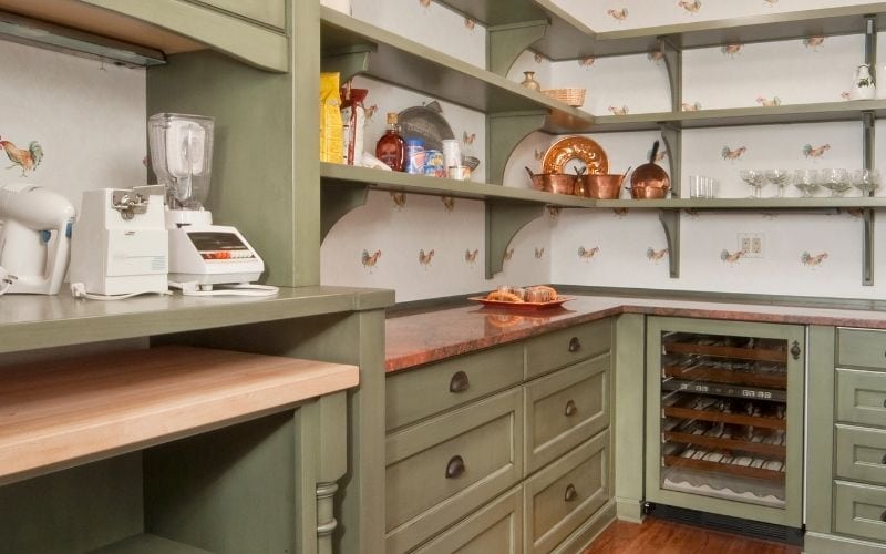 Image of a kitchen with green colored cabinets