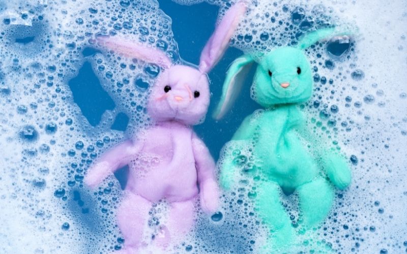 Photo of two stuffed toys soaked in a soapy water