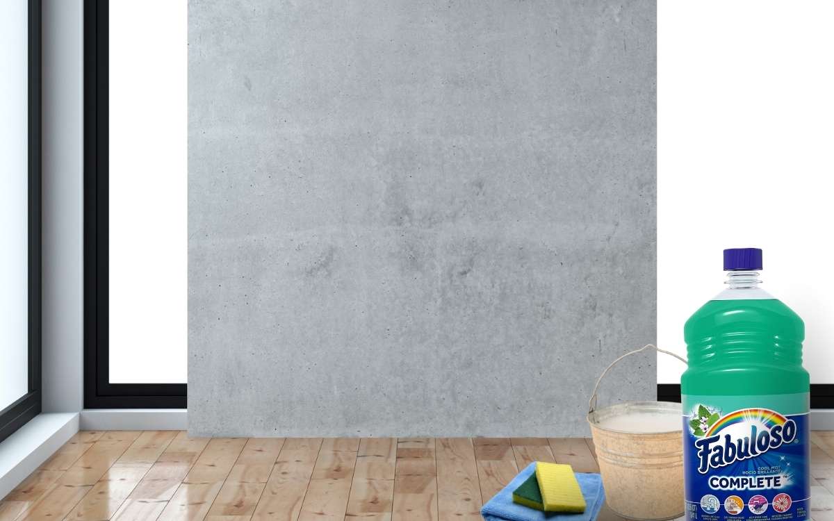 Photo of a grey colored wal in a large room with cleaning items on the wooden floor