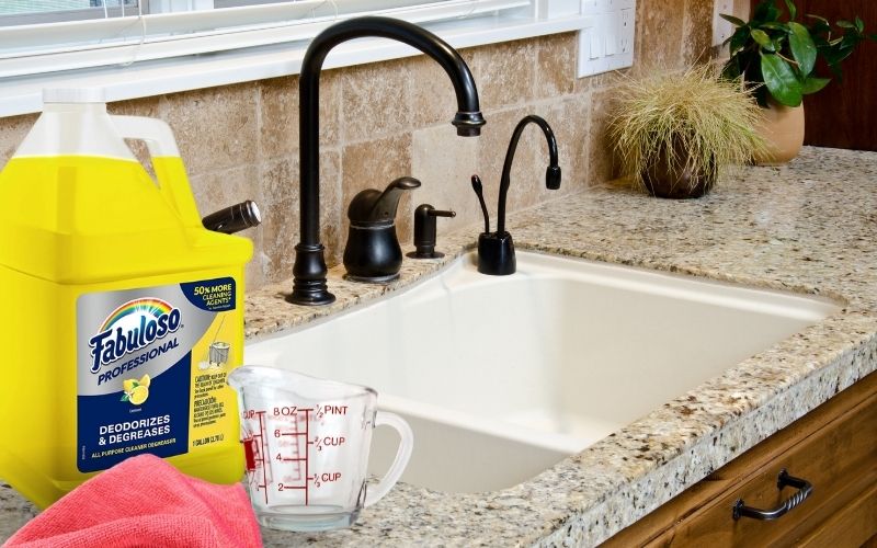 Image showing counter top with sink, fabuloso a measuring cup and a cloth