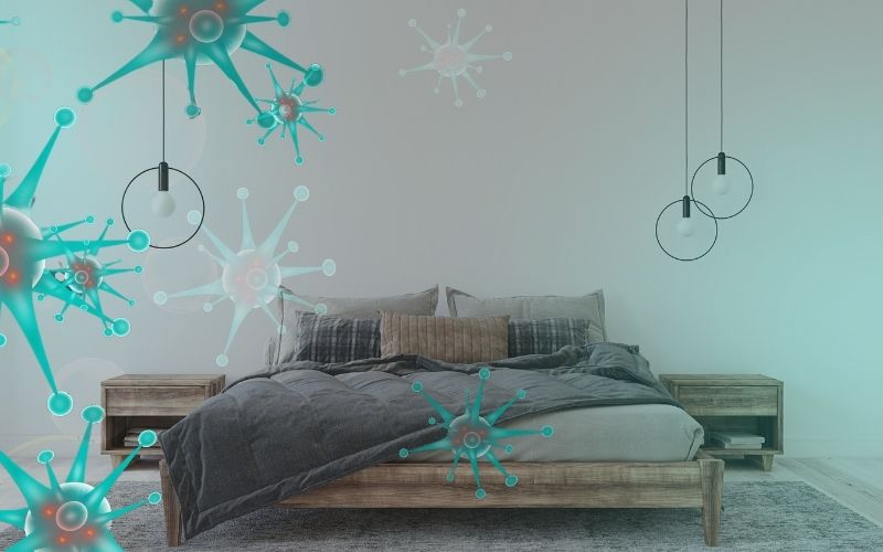 image of a dim bedroom with microbe-looking floating on air