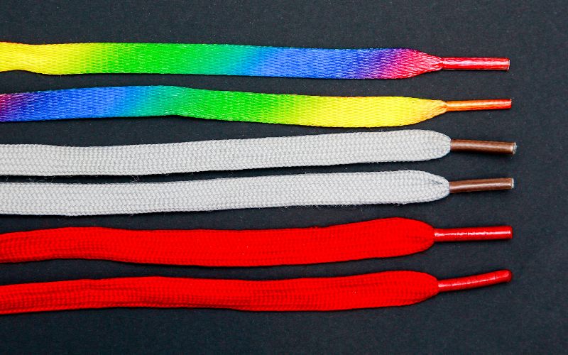 three pairs of shoelaces with diffrent colors in black background