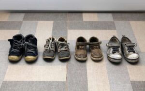 Four pairs of dirty colored shoes that can be cleaned using baking soda